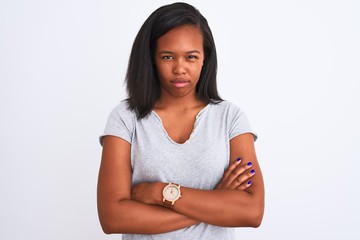 Beautiful young african american woman wearing casual t-shirt over isolated background skeptic and nervous, disapproving expression on face with crossed arms. Negative person.