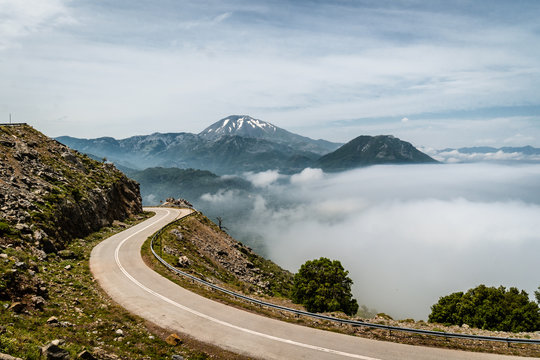 Mountain road with a view of the Dirfi moutain peak in the Euboea island in Greece while the fog comes up