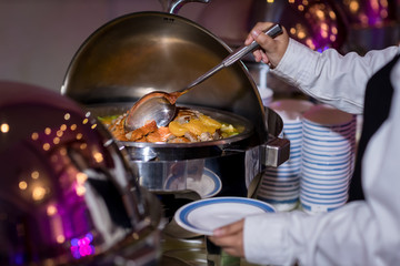 Naklejka premium Food Buffet Catering Dining Eating Party Sharing Concept.people group catering buffet food indoor in luxury restaurant with meat colorful fruits and vegetables