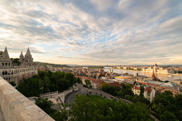 Fototapeta na wymiar Sunset over the Fisherman's Bastion and the parliament house in Budapest by the Danube in Hungary capital city old town