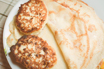 Fried curd cheese cakes on pancakes in plate.