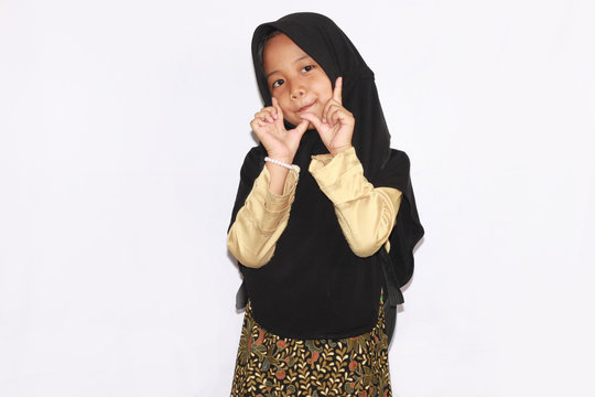 Portrait of cute A  young asian little girl 6-7 years old muslim, wearing hijab, show face  expression