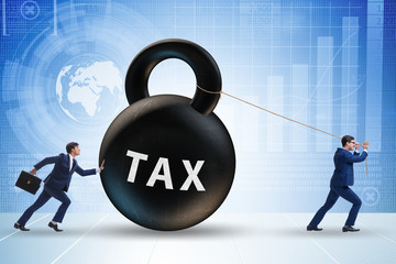 Businessman pulling kettlebell in tax concept