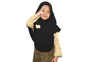 Portrait of cute A  young asian little girl 6-7 years old muslim, wearing hijab, show face  expression