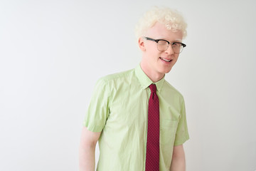 Young albino businessman wearing shirt and tie standing over isolated white background winking...