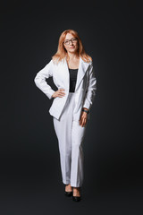 Stylish mature businesswoman on dark background