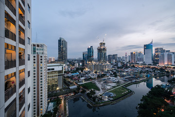 Fototapeta na wymiar Twilight over the Jakarta business district in Indonesia capital city