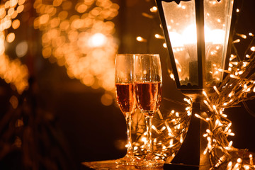 Two glasses of champagne over blur spots lights background. Celebration, free space for text