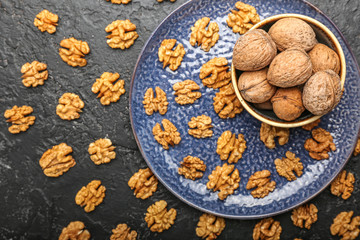 Composition with tasty walnuts on dark background