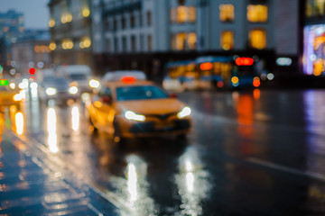 Fototapeta na wymiar Wet night city street rain Bokeh reflection bright colorful lights puddles sidewalk Car