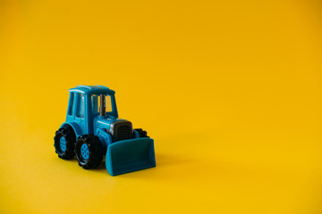 Fototapeta premium Toy blue agricultural tractor