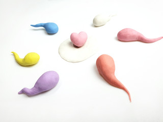 Active sperm cells swim to the egg on a white background. The concept of pregnancy, fertilization of the egg