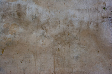 Concrete surface painted in light pastel colors with a rough texture.