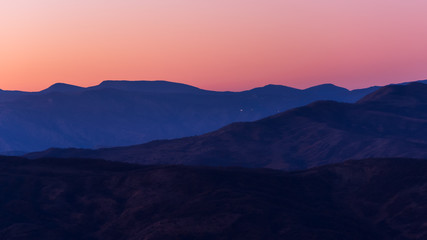 Silhouetted mountain range after sunset