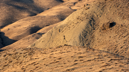 Camera and tripod on top of a mountain