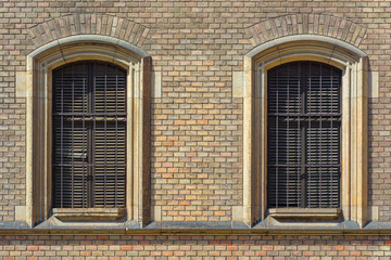 Windows with a powerful protective grill in an old urban residential building.