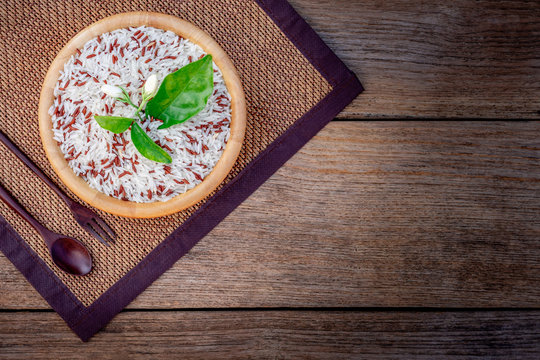 bowl of  rice and jasmine flower on wood background