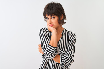 Young beautiful woman wearing striped shirt standing over isolated white background thinking looking tired and bored with depression problems with crossed arms.