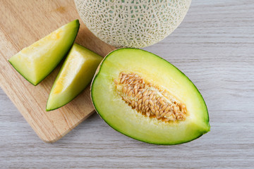 Slice of Japanese melons,honey melon or cantaloupe  isolated on wood background. fruit and supplements for good health
