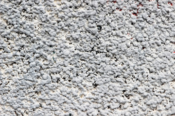 Texture of a wall made of crushed stone plastered with cement. Rock dash stucco used as an exterior coating on a house wall