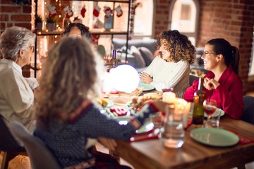 Beautiful group of women smiling happy and confident. Eating roasted turkey celebrating christmas at home