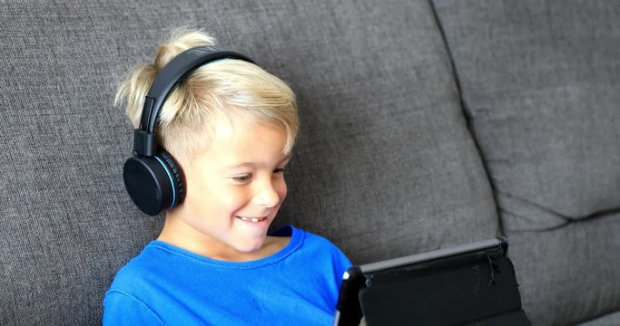 Little boy playing on tablet. The child spends his free time with modern technology. Stabilized video.