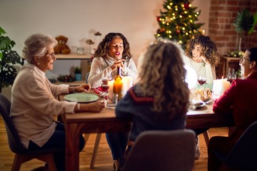 Beautiful group of women smiling happy and confident. Eating roasted turkey celebrating christmas at home