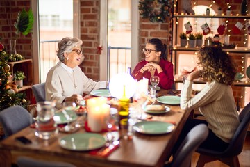 Beautiful group of women smiling happy and confident. Eating roasted turkey celebrating christmas at home