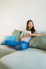 Portrait beautiful young asian woman on sofa with coffee cup