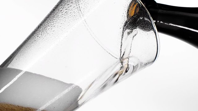Pouring yellow beer on white background. Barm, bubble fresh drinking, foamy golden alcohol.