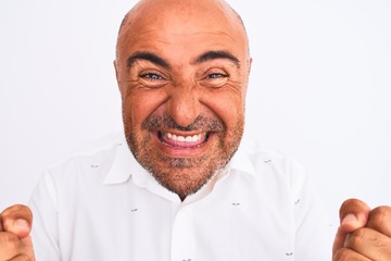Middle age handsome man wearing elegant shirt standing over isolated white background screaming proud and celebrating victory and success very excited, cheering emotion