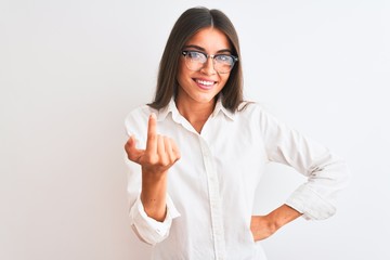 Young beautiful businesswoman wearing glasses standing over isolated white background Beckoning come here gesture with hand inviting welcoming happy and smiling