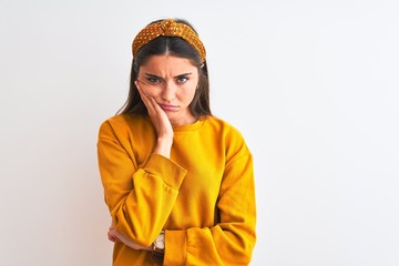 Young beautiful woman wearing yellow sweater and diadem over isolated white background thinking looking tired and bored with depression problems with crossed arms.