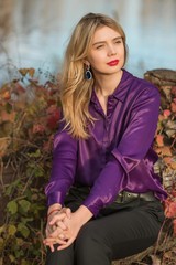 Obraz premium Nice woman, American or European appearance enjoying life. Young lady, stylishly dressed in purple blouse at nature .Natural beauty 
