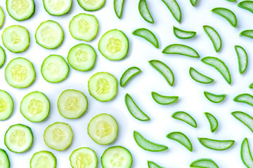 Closeup fresh organic aloe vera and cucumber sliced isolated on white background. Pattern texture for beauty and spa concept.Herbal medicine plant concept. Top view. Flat lay.