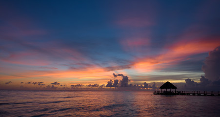 Naklejka na ściany i meble sun sea tropical sunset view of the pier of the caribbean