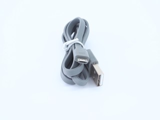 Gray usb cable on a light blue background