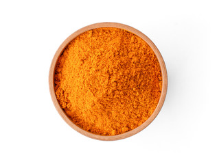 Closeup turmeric ( known as curcumin, Curcuma longa Linn) powder in wooden bowl isolated on white background with clipping path.Top view. Flat lay. - obrazy, fototapety, plakaty