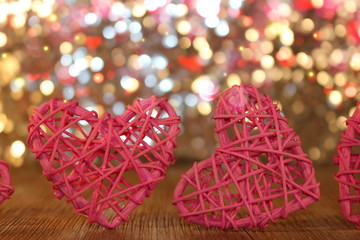 Fototapeta na wymiar beautiful pink heart rattan heart on shiny background