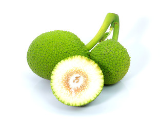 Close up heap of breadfruit (known as bread nut, Artocarpus altillis) and cut in half sliced isolated on white background . Natural herbal plant concept.