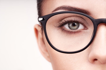 Female eye with long eyelashes in eyeglasses. Model in glasses. Vision correction. Poor eyesight....