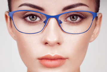 Female eye with long eyelashes in eyeglasses. Model in glasses. Vision correction. Poor eyesight. Spectacle frame. Makeup, cosmetics, beauty. Close up, macro