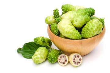 Noni fruit or Morinda citrifolia( known as indian mulberry, cheese fruit) and sliced with seeds and green leaf isolated on white background.