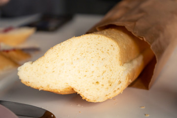 Close-up of baguette for breakfast on a white table in the kitchen in the morning. 