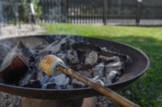 Roasting marshmallows over an open campfire