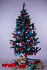 green christmas tree with toys and garland