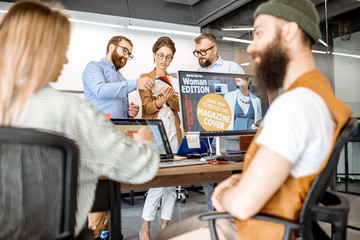 Group of diverse creative people working as a web designers in the modern office, young couple...