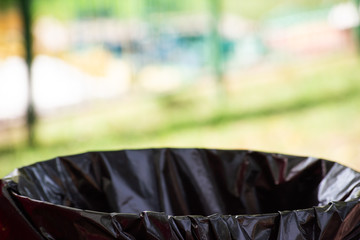 Black bag on a trash basket on outdoors