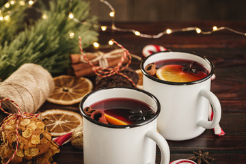 Two cups of Christmas mulled wine on a wooden table
