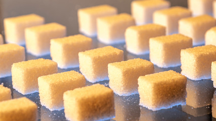 Pieces of sugar on glass as an abstract pattern
